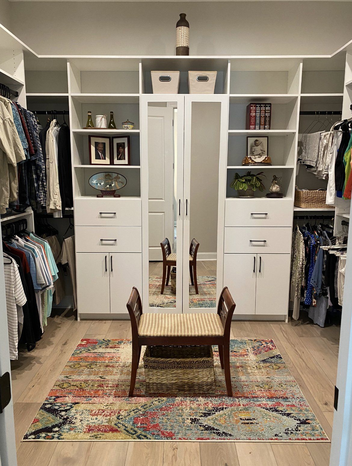 There is a bench in the middle of the closet.