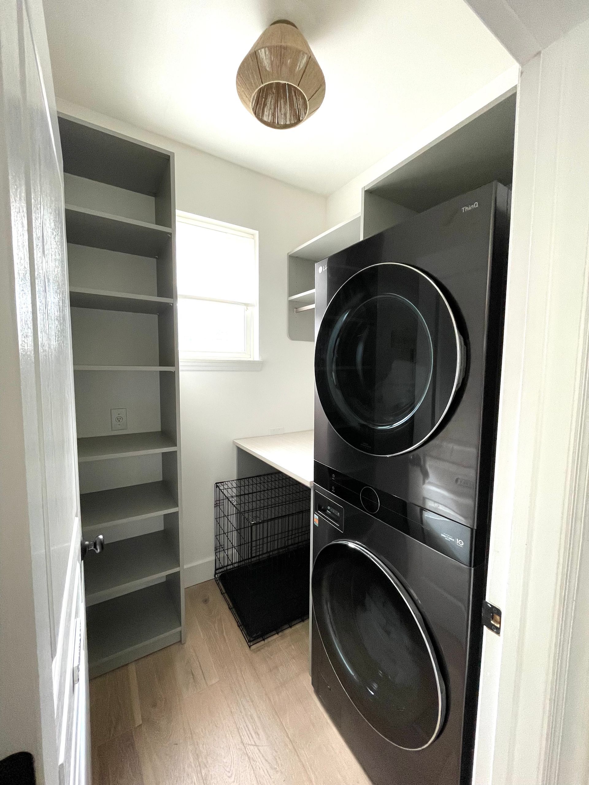 A laundry room with a washer and dryer stacked on top of each other.