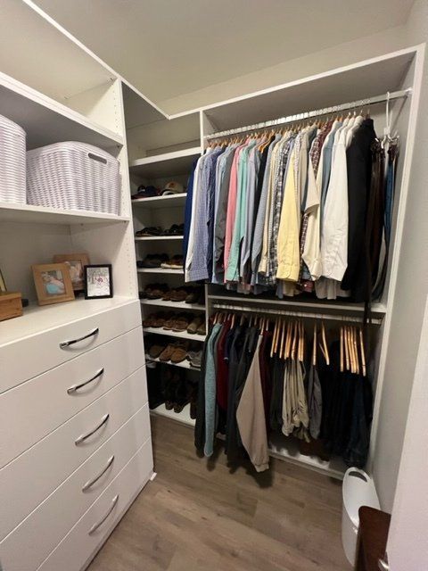 A walk in closet filled with clothes and shoes