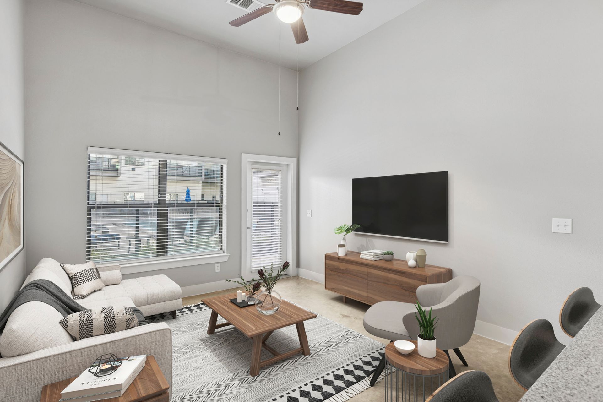 Living room with white walls, TV, couch, chair, and coffee table.