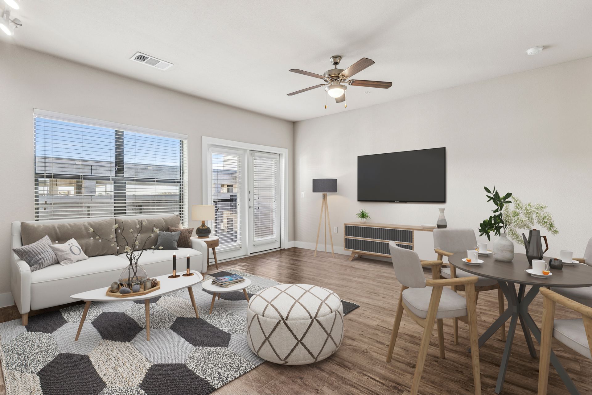 Bright living room with white walls, large windows, and modern furniture.