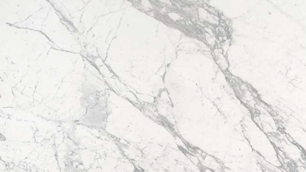 A close up of a white marble counter top.