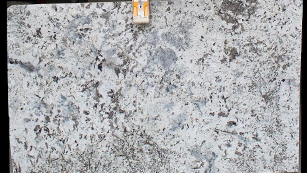 A close up of a white granite slab on a black background.