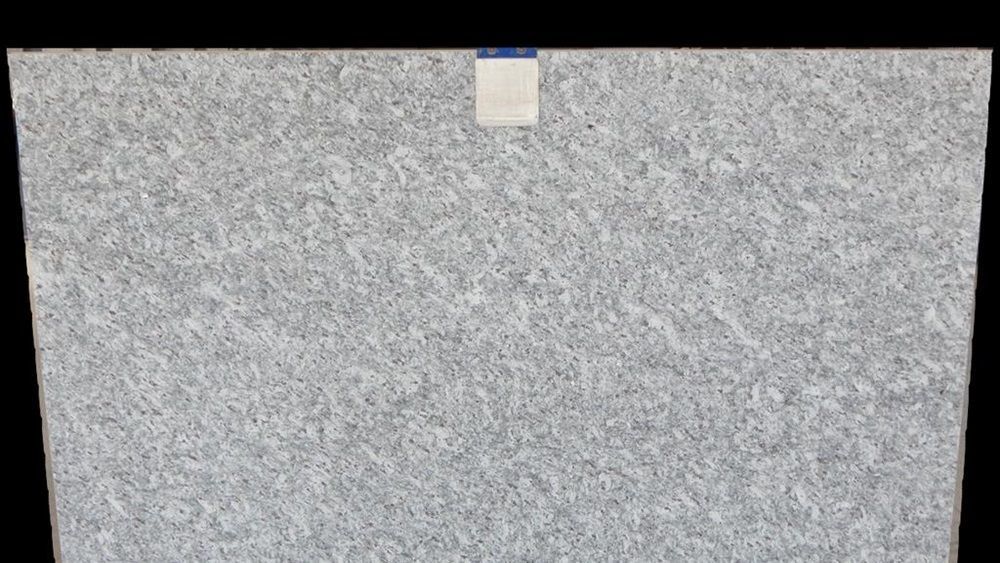 A close up of a gray granite slab on a black background.