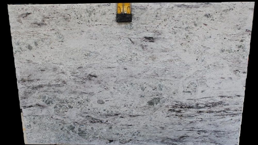 A close up of a white granite slab on a black background.
