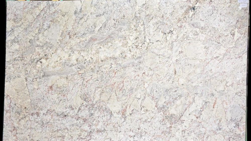 A close up of a white granite slab on a black background.