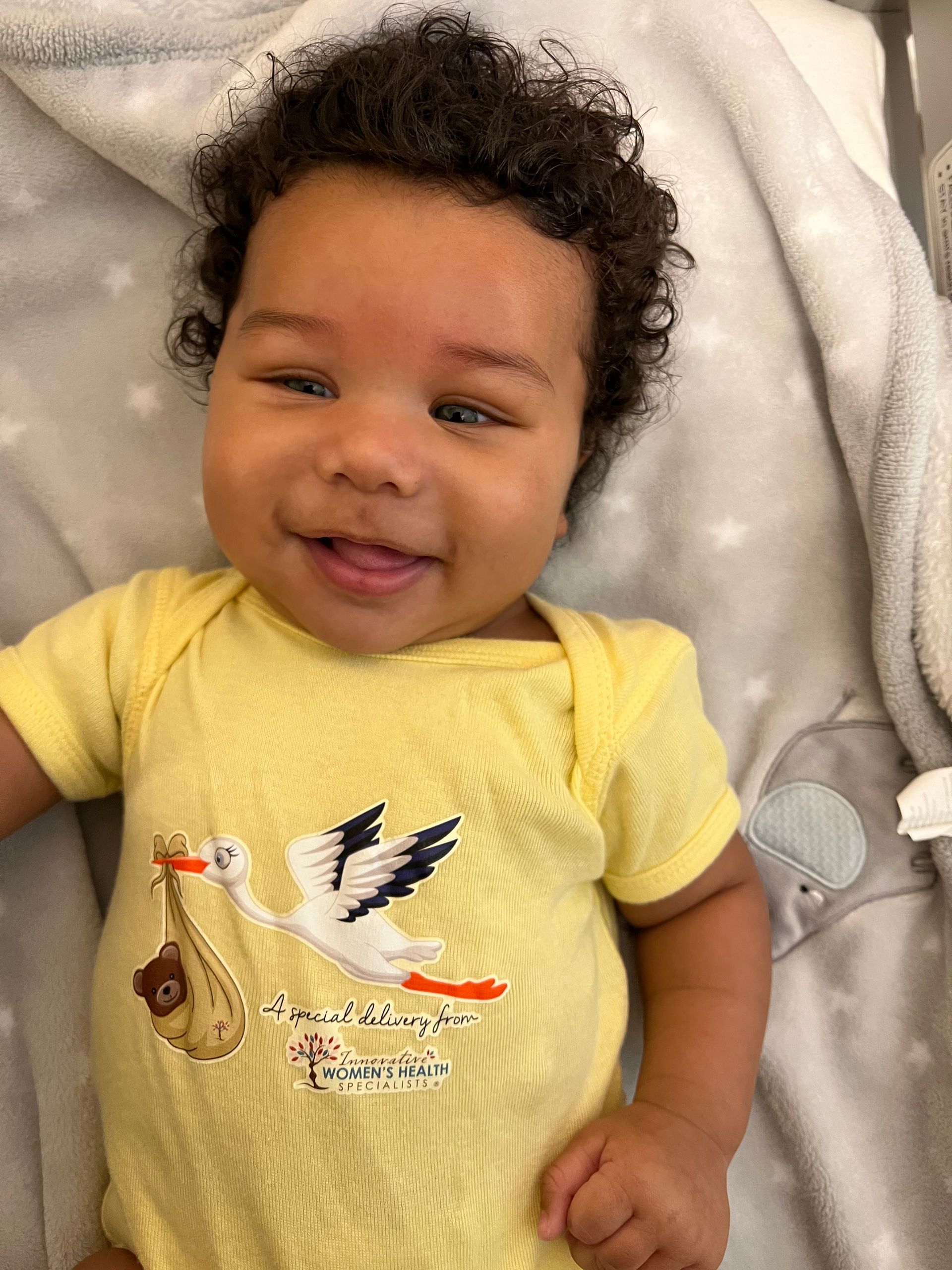 A Baby With A Curly Hair Wearing A Yellow Shirt - Chattanooga, TN - Innovative Women's Health Specialists