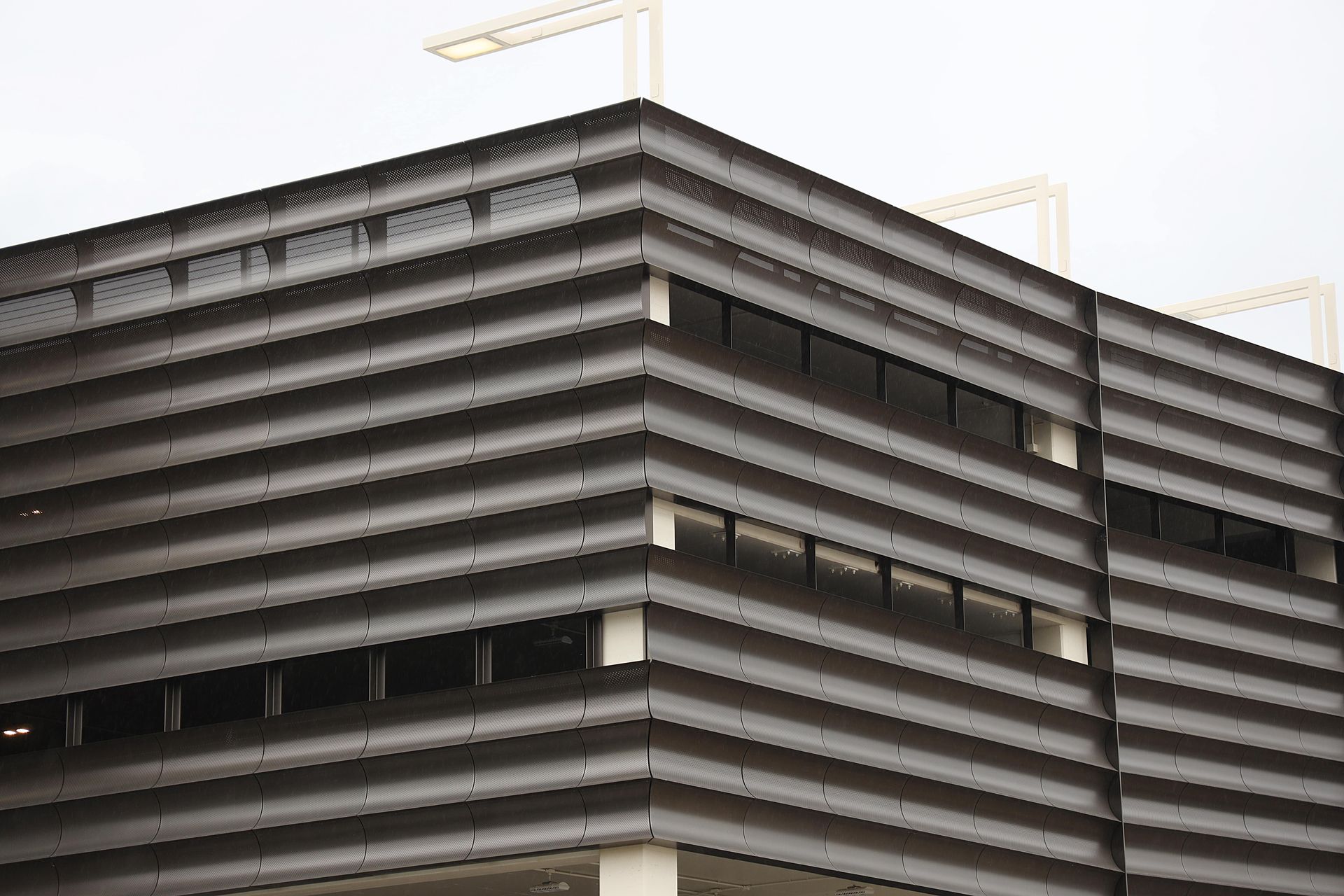 A large building with a lot of windows is under construction.