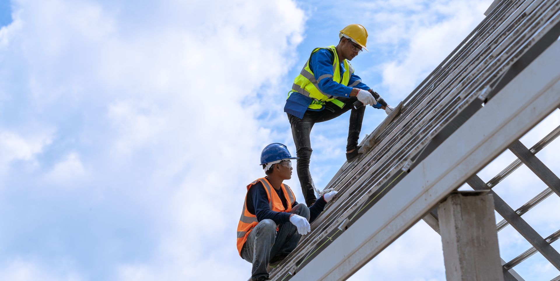 Construction worker installing new roof at construction site.