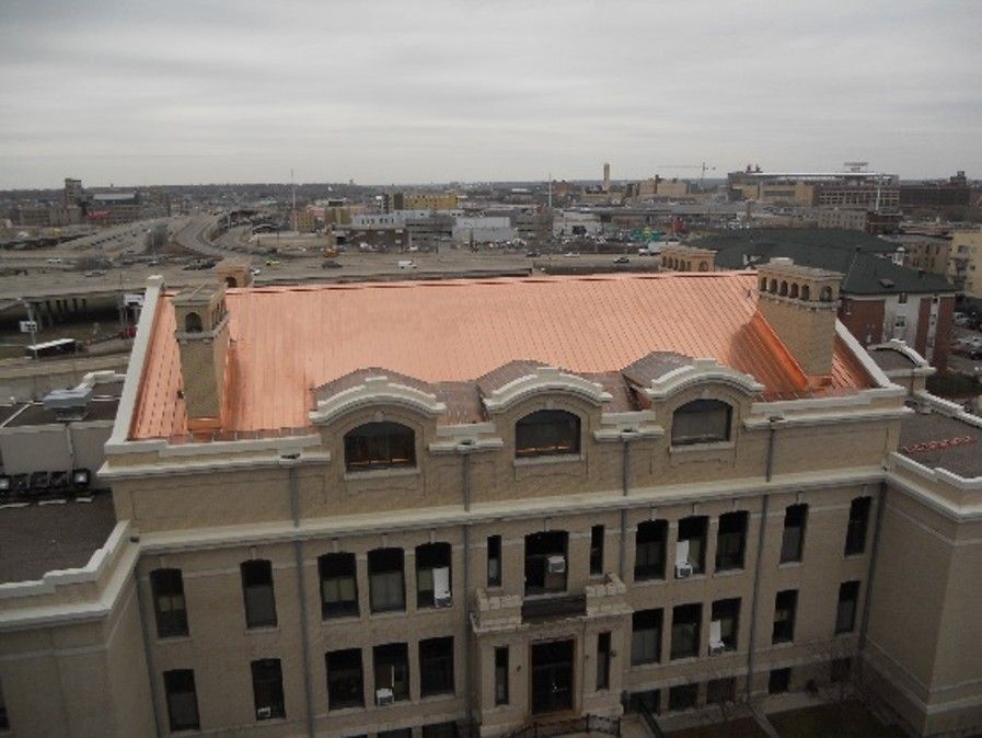 Aerial view of a completed copper metal roof installation on a commercial building in Minneapolis, MN Aerial view of a completed copper metal roof installation on a commercial building in Minneapolis, MN