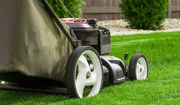 Lawn Mower On Grass Field — Carencro, LA — Boudreaux’s Lawn Service