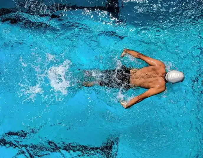 A swimmer performs a stroke in a pool.