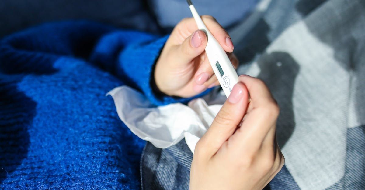 A person is holding a thermometer in their hand.