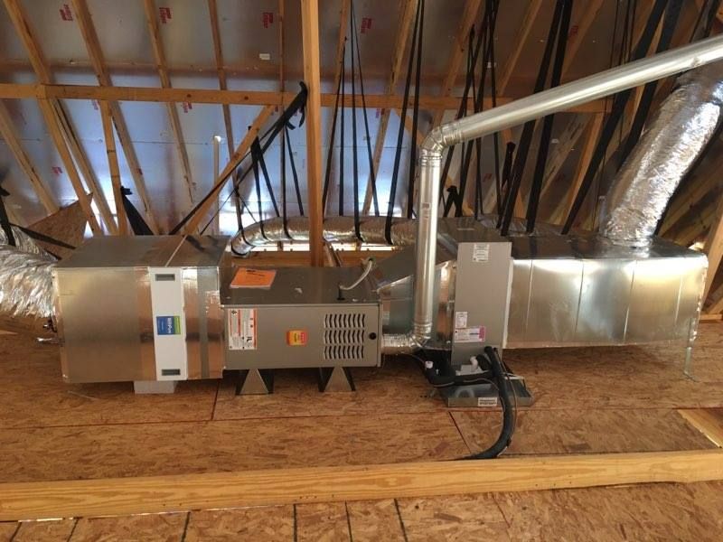 There is a ventilation system in the attic of a house.