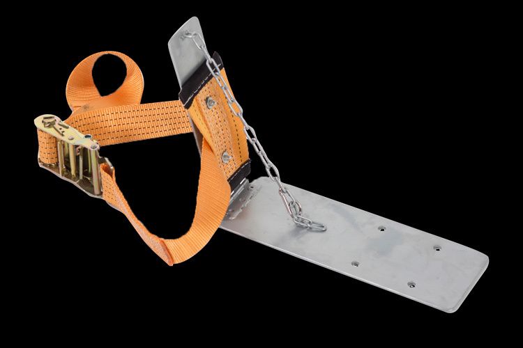 A piece of metal with a strap attached to it on a black background.