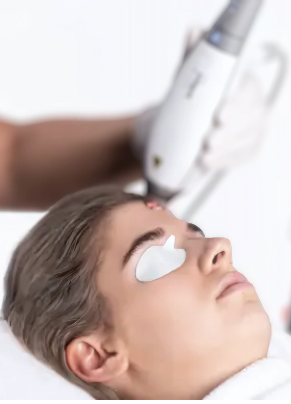 A woman is getting Clear and Brilliant Laser treatment on her face.