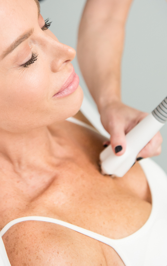 A woman is getting Venus Legacy RF Facial Skin Tightening treatment from a medical expert.