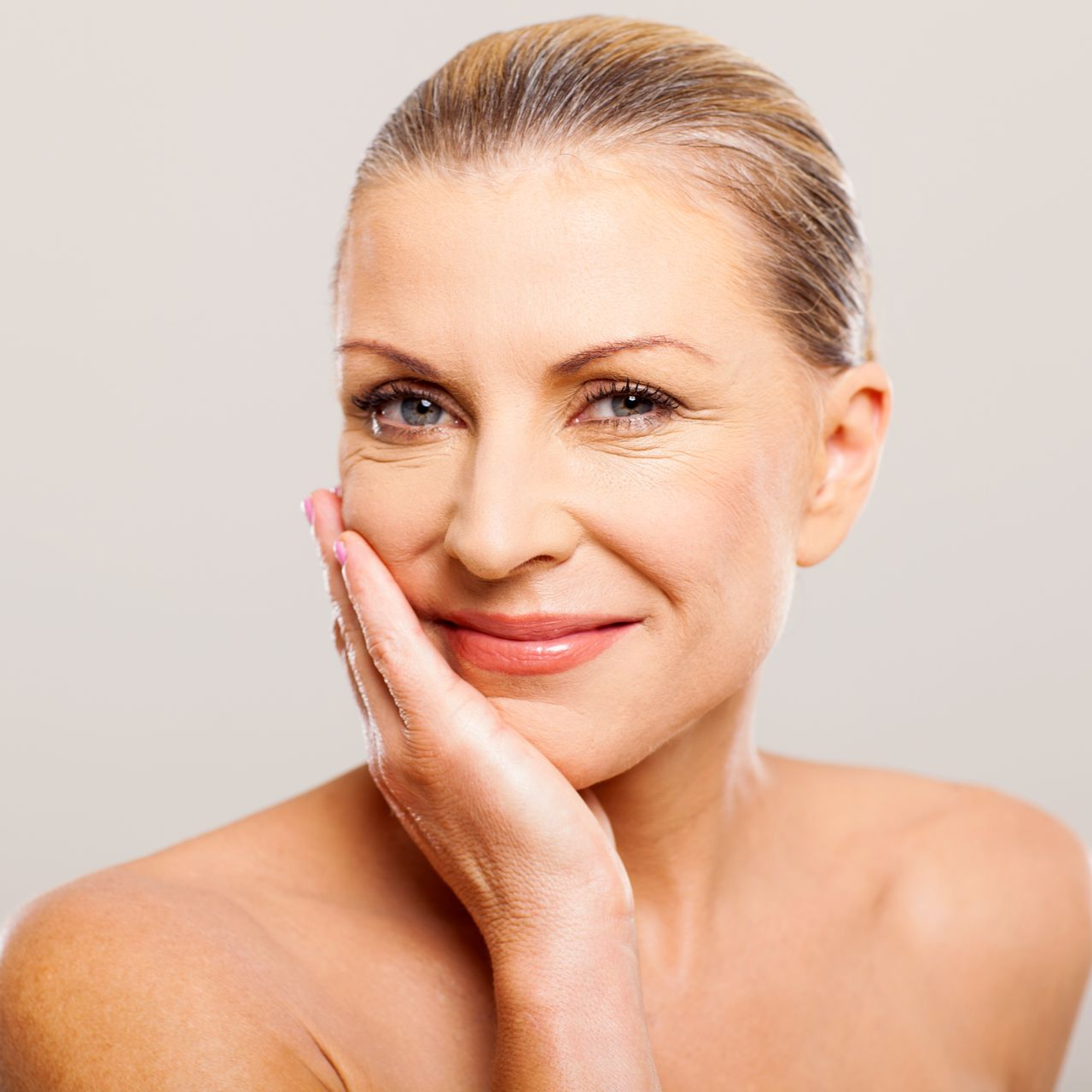 Close-up of a fair-skinned person's face with flushed cheeks and slightly glossy skin; golden light.
