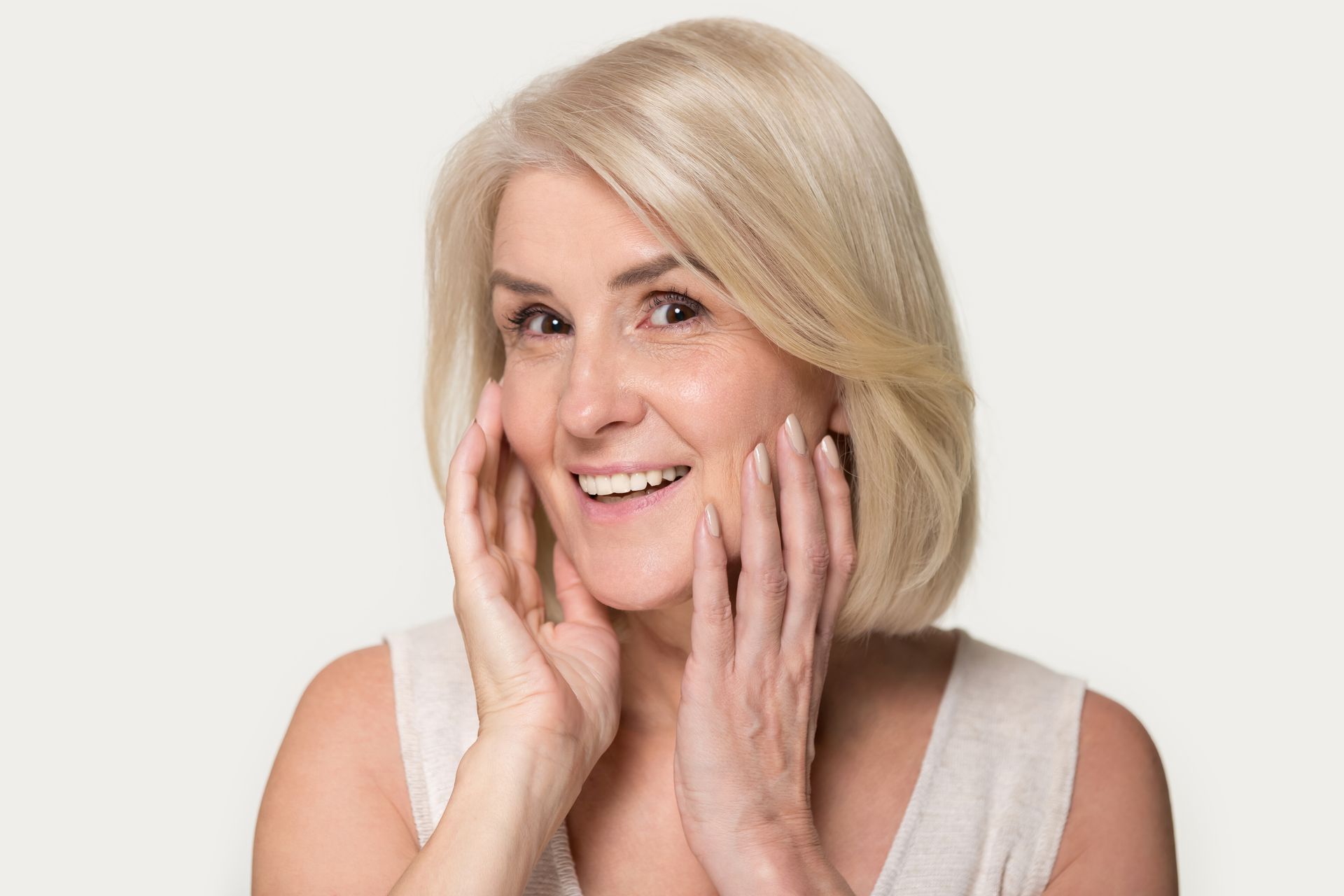 A woman is smiling after getting Chemical Peels treatment.