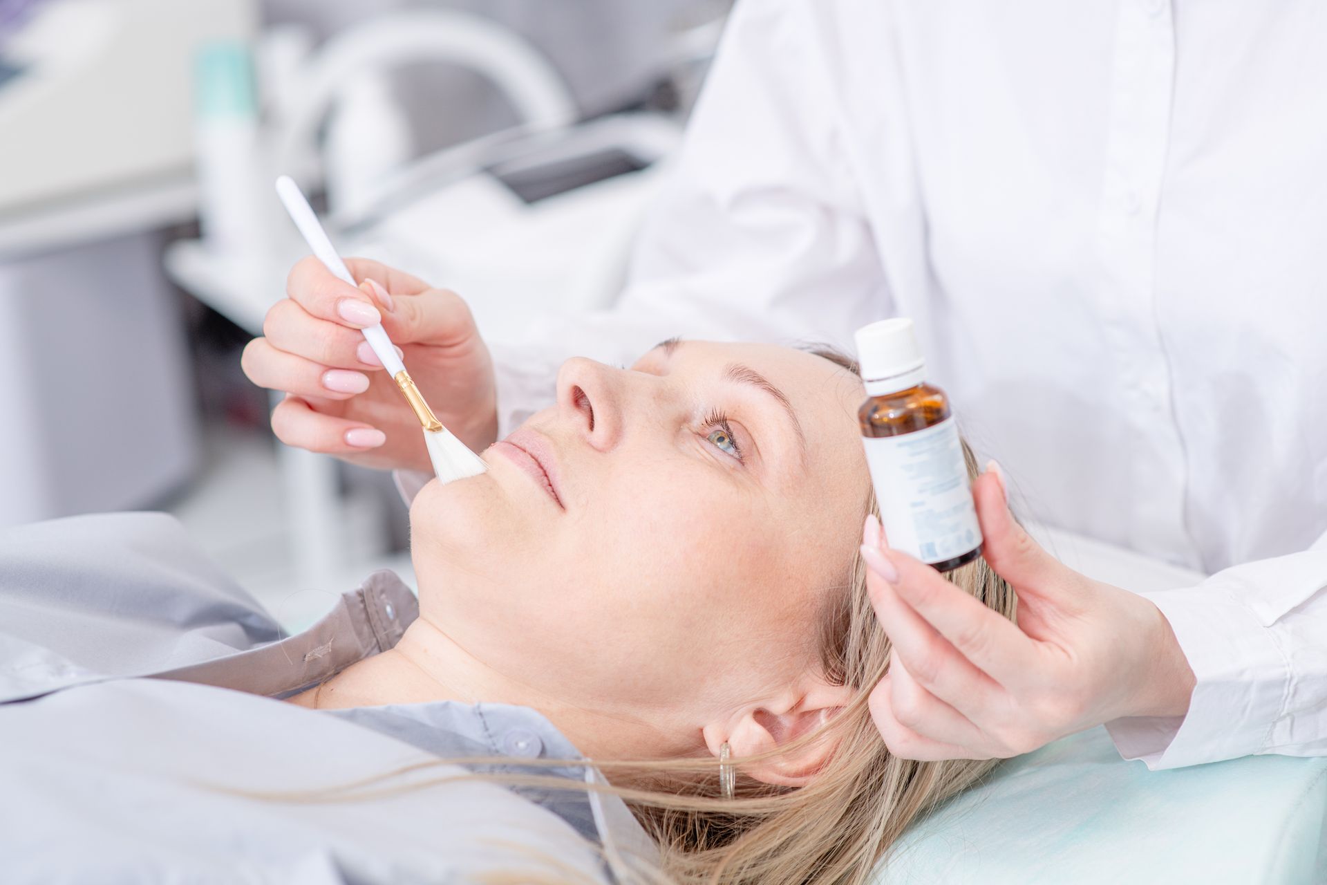 A woman is getting a facial treatment at a beauty salon.