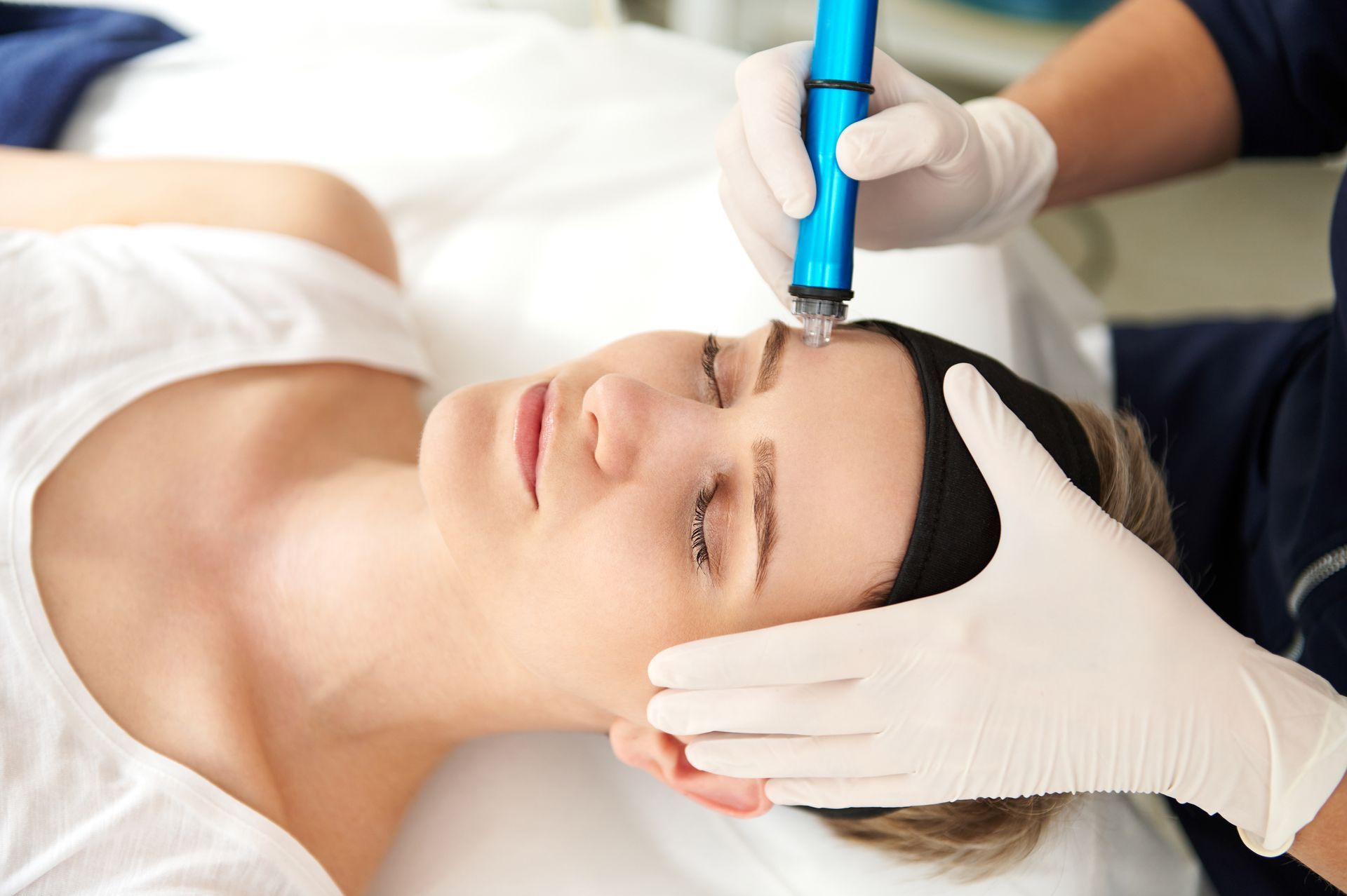 A woman is getting a facial treatment at a beauty salon.