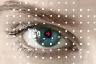A close up of a woman 's eye with a red cross in the center.