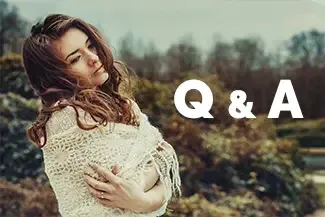 A woman in a white sweater is standing in a field with her arms crossed with a Q & A text overlay.