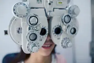 A woman is getting her eyes checked by an ophthalmologist.