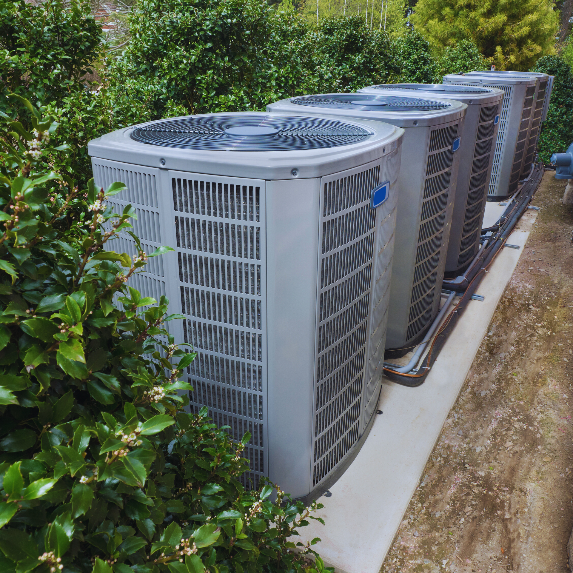 Hands in yellow gloves connecting plumbing under a sink.