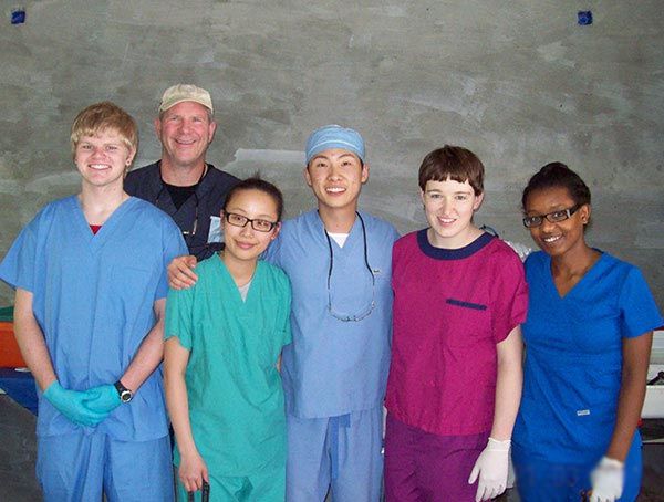 A group of doctors and nurses posing for a picture
