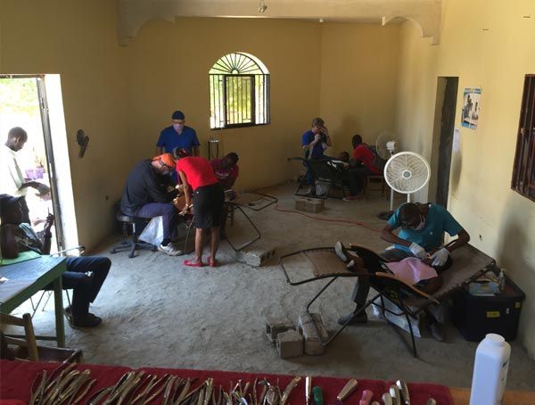 A group of people are sitting around a table in a room.
