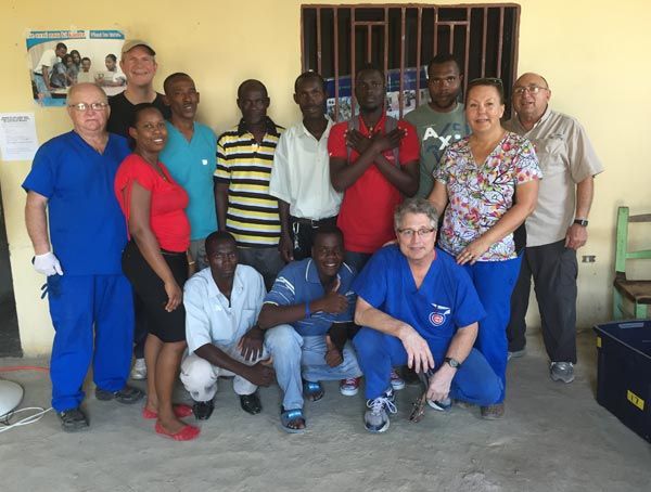 A group of people posing for a picture with one man wearing a shirt that says ' chicago ' on it