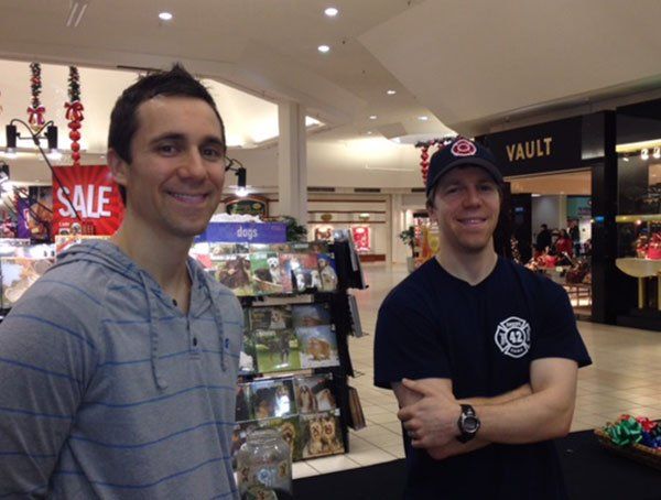 Two men are standing in front of a vault store