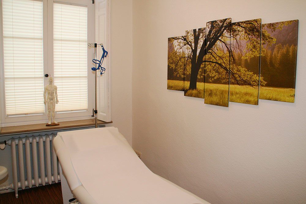 Ein Zimmer mit einem Bett und einem Gemälde an der Wand.