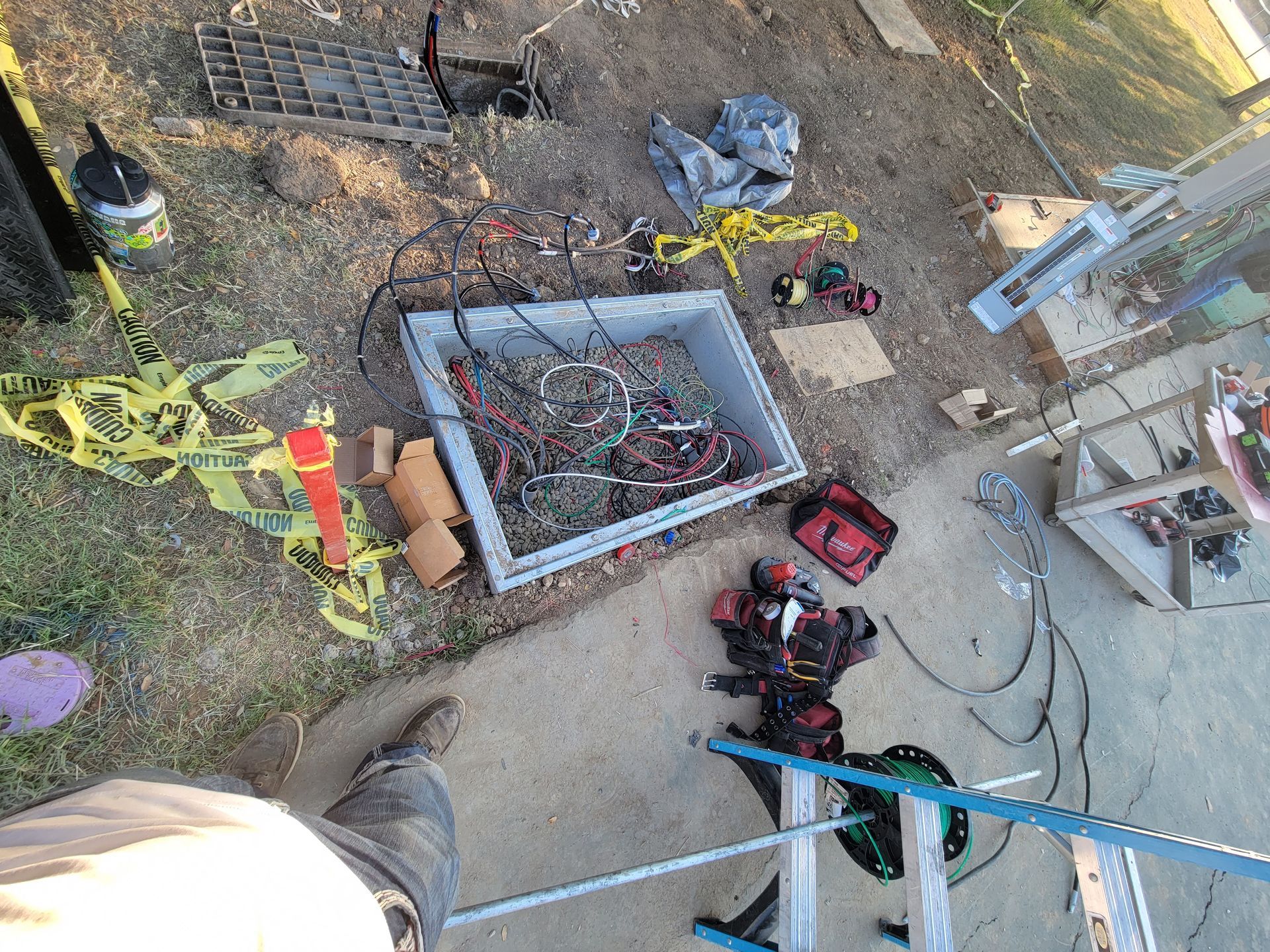 Overhead view of workers and tools around a dug-out area at a construction site