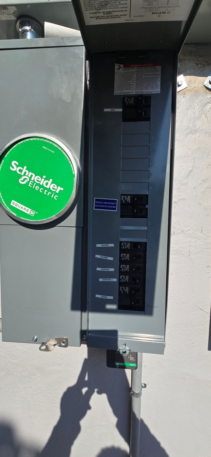 Outdoor utility meter box with a green “Synergy” sticker and keypad panel on a pole