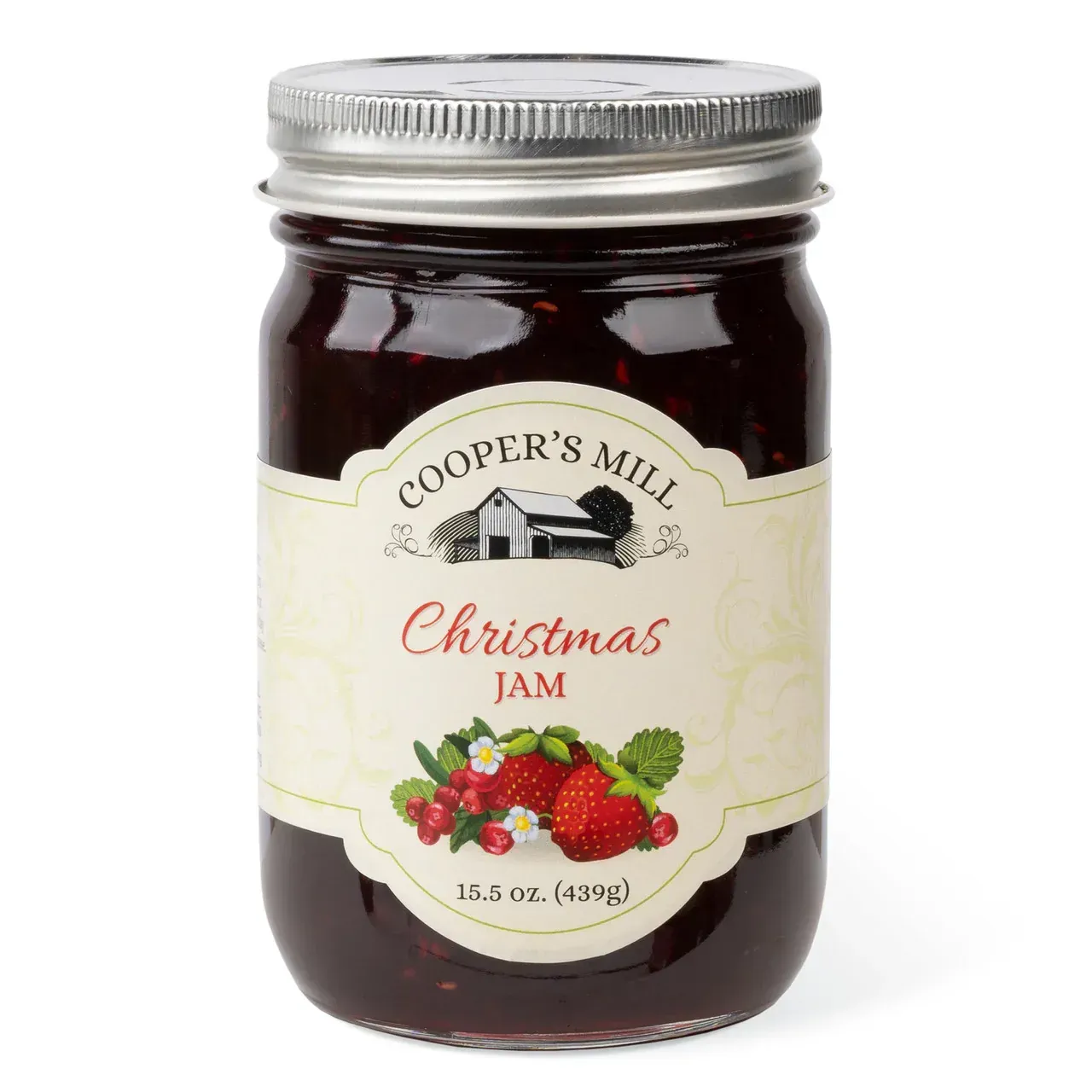 A jar of cooper 's mill christmas jam with strawberries and cranberries on a white background.