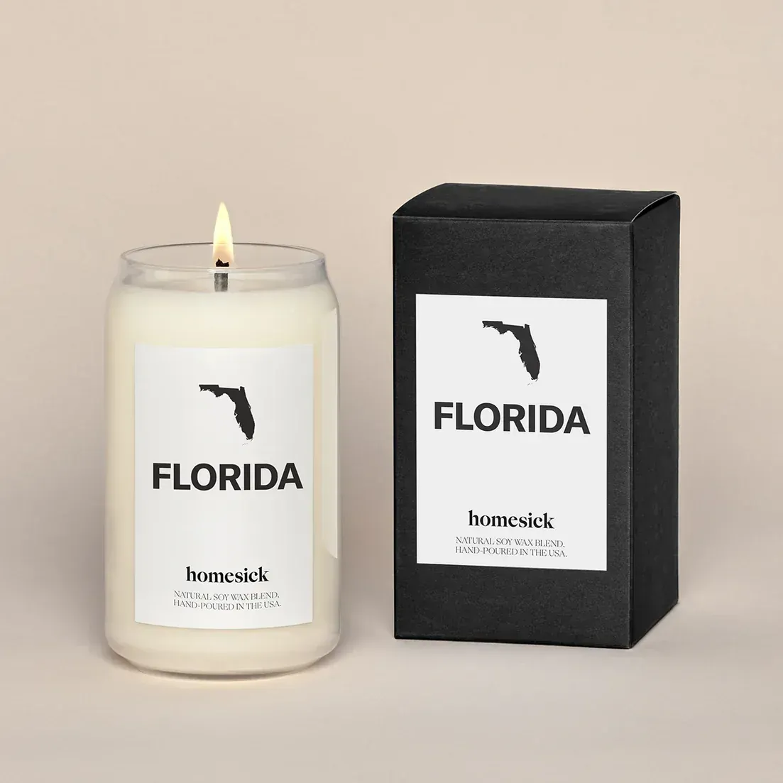 A candle with a label that says florida next to a box