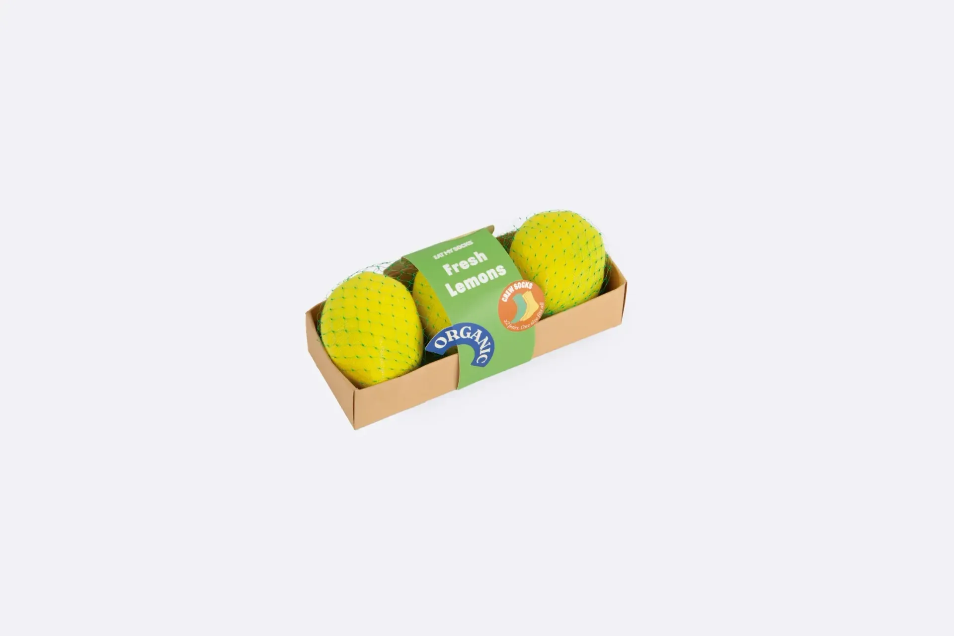 Three lemons in a cardboard box on a white background.
