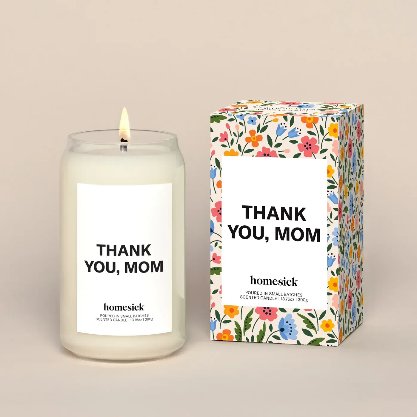 A candle that says thank you mom next to a box