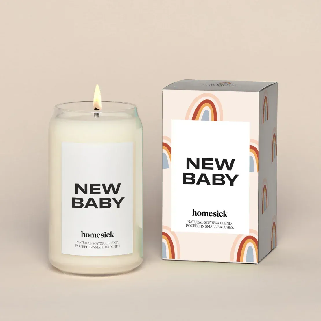 A candle that says new baby next to a box
