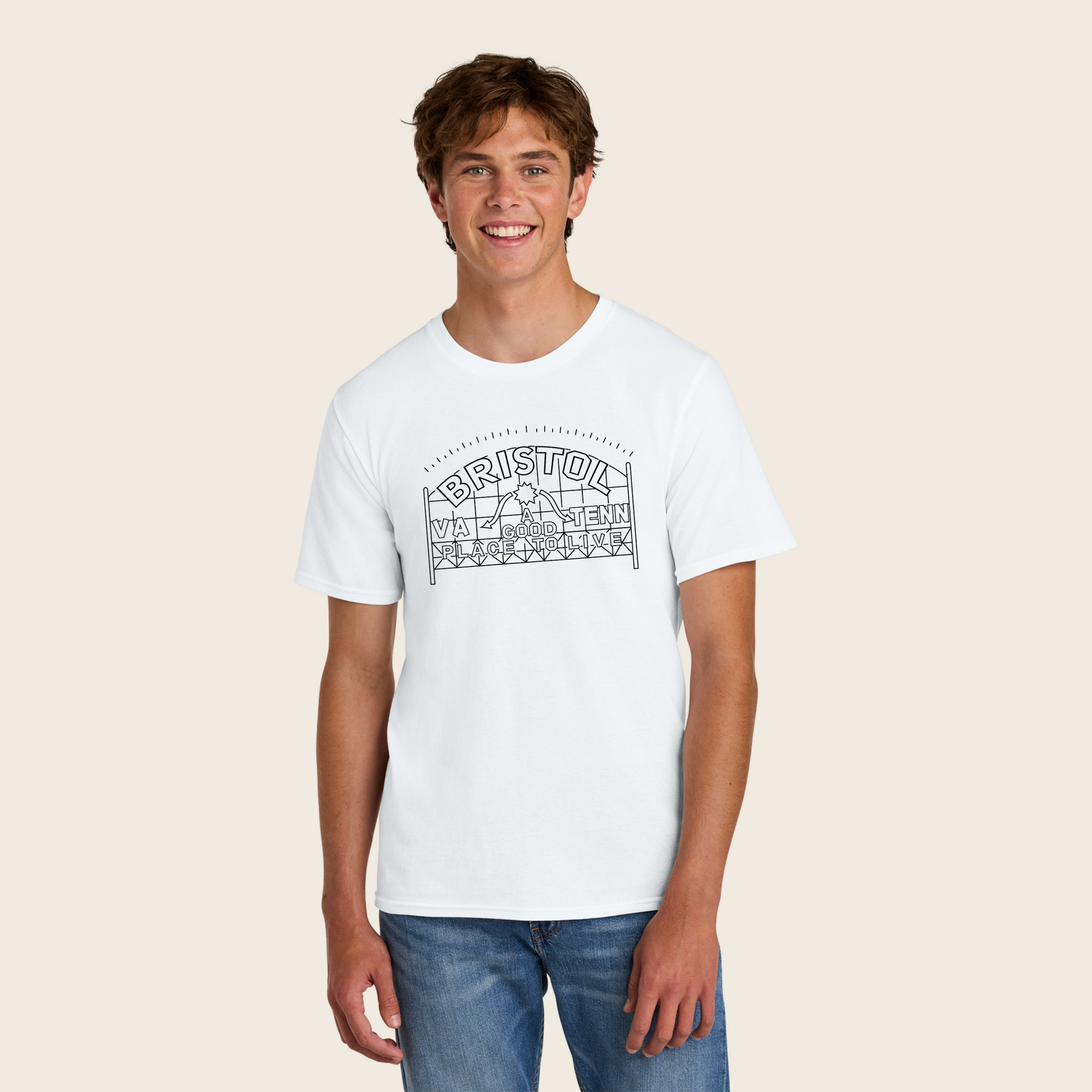 A man wearing a white t-shirt and jeans is smiling.