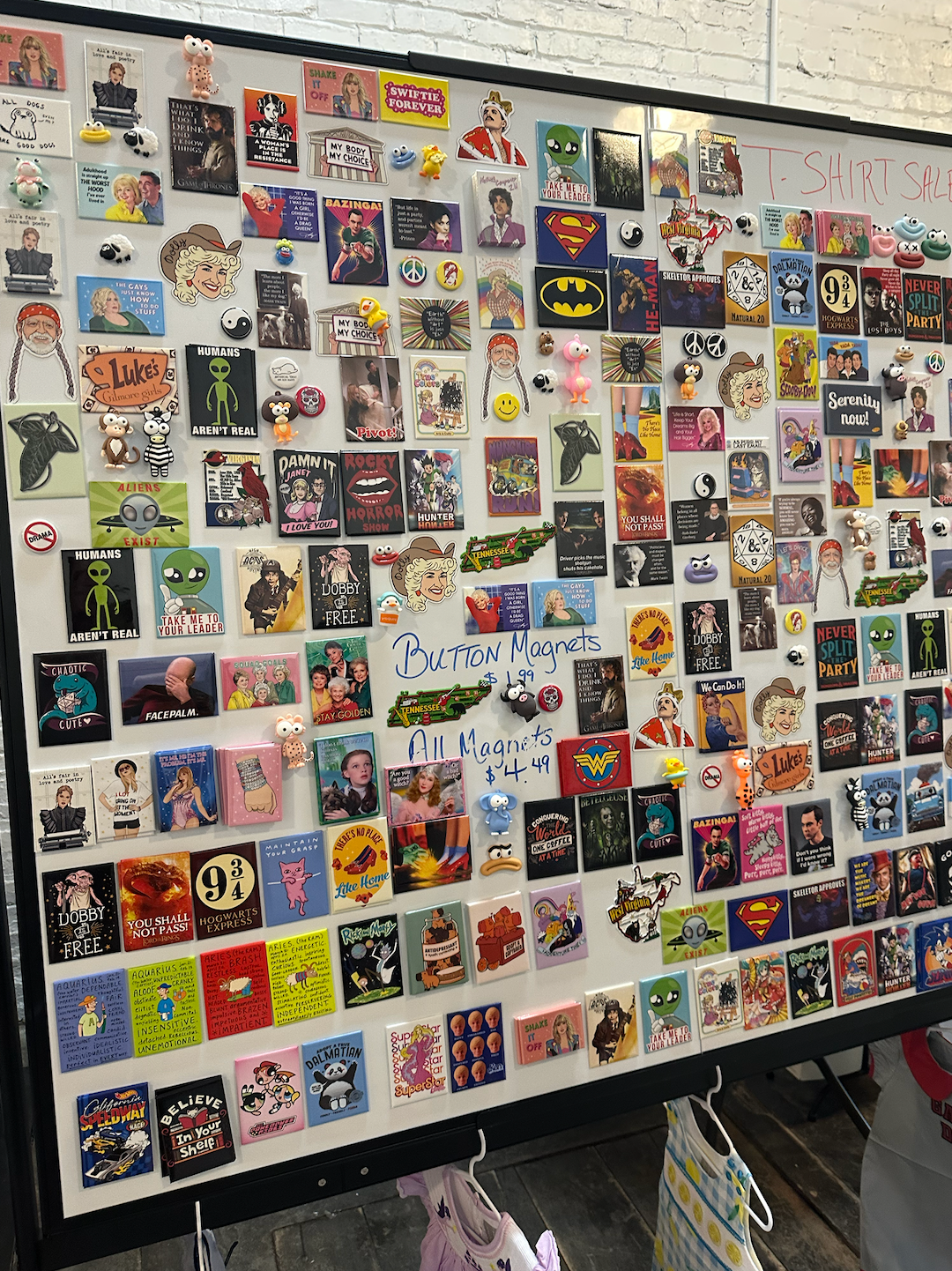A whiteboard with a lot of magnets on it