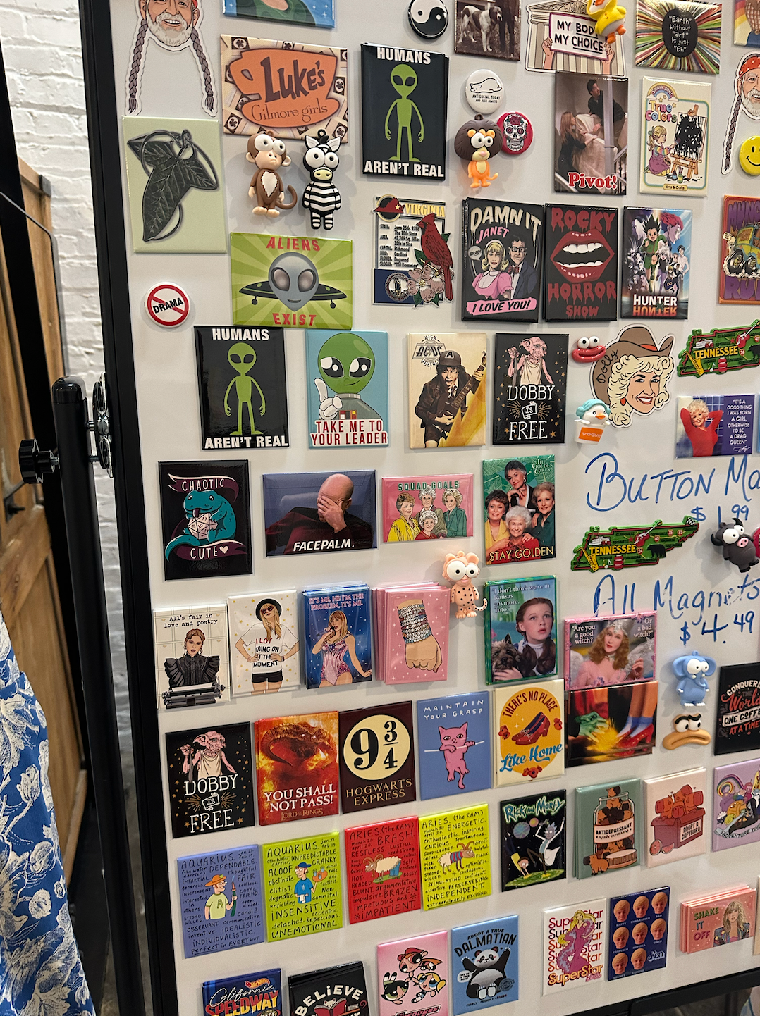 A fridge with a lot of magnets on it