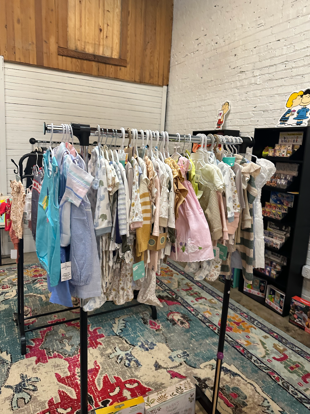 A room filled with lots of clothes hanging on racks.
