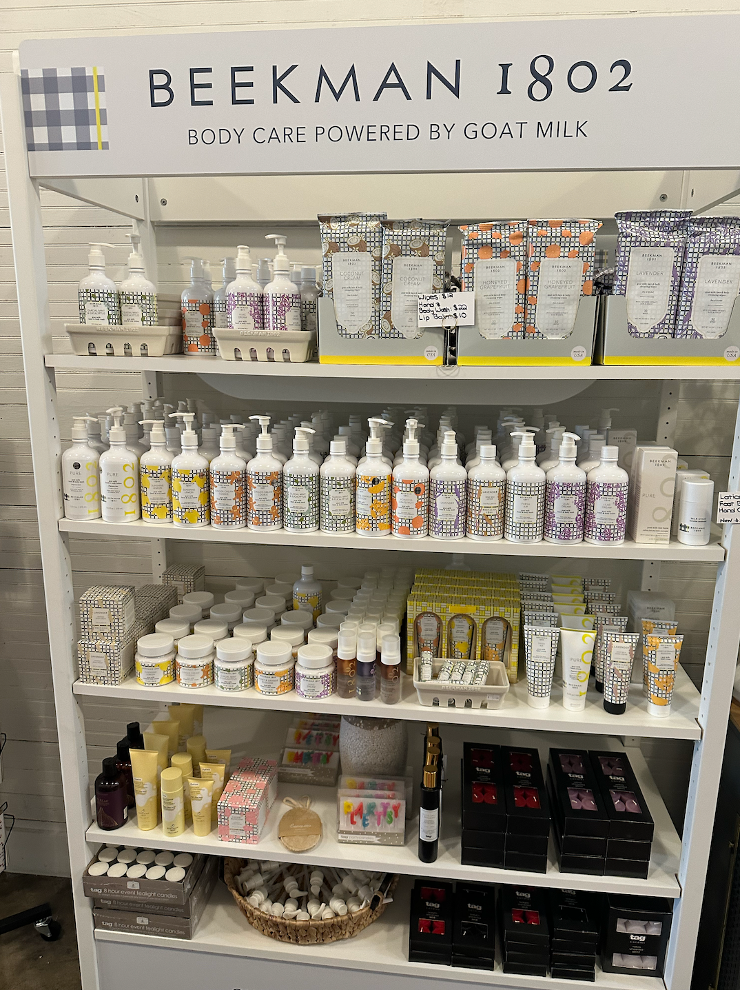 A shelf filled with lots of bottles and boxes of cosmetics.