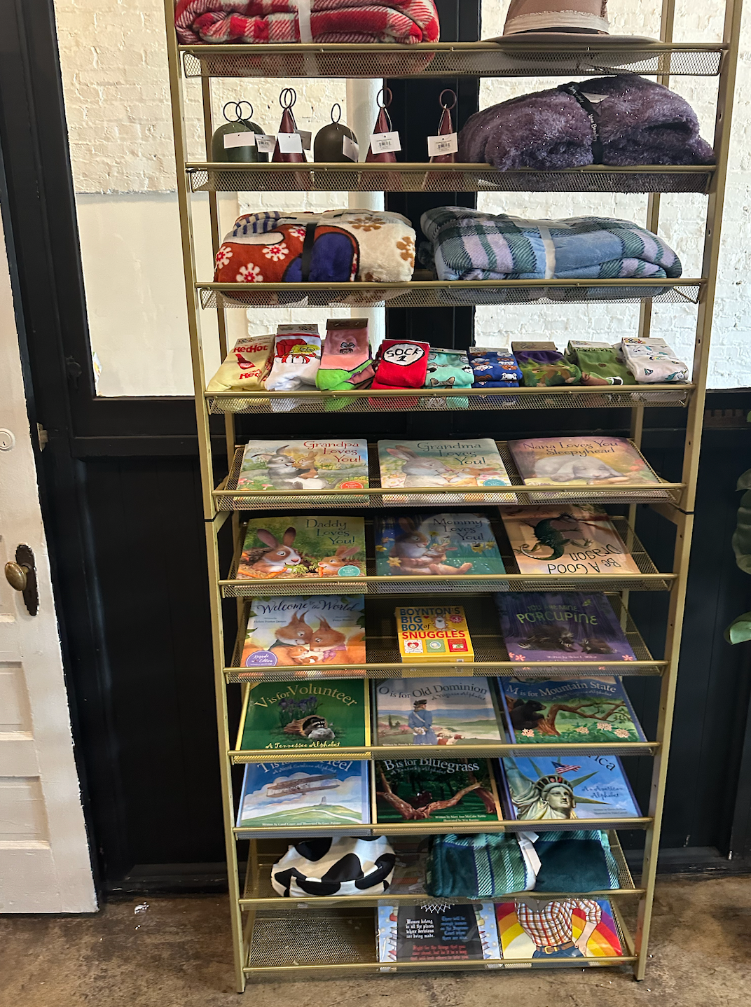 A shelf filled with lots of books and other items.