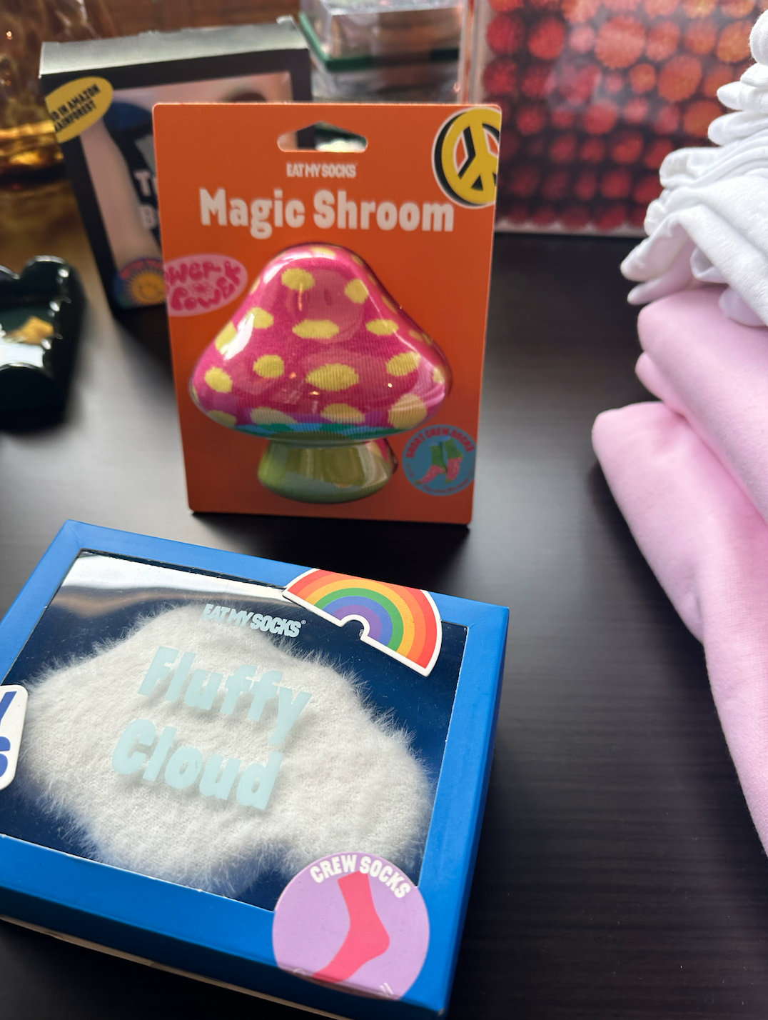 A box of magic shroom next to a box of fluffy cloud socks