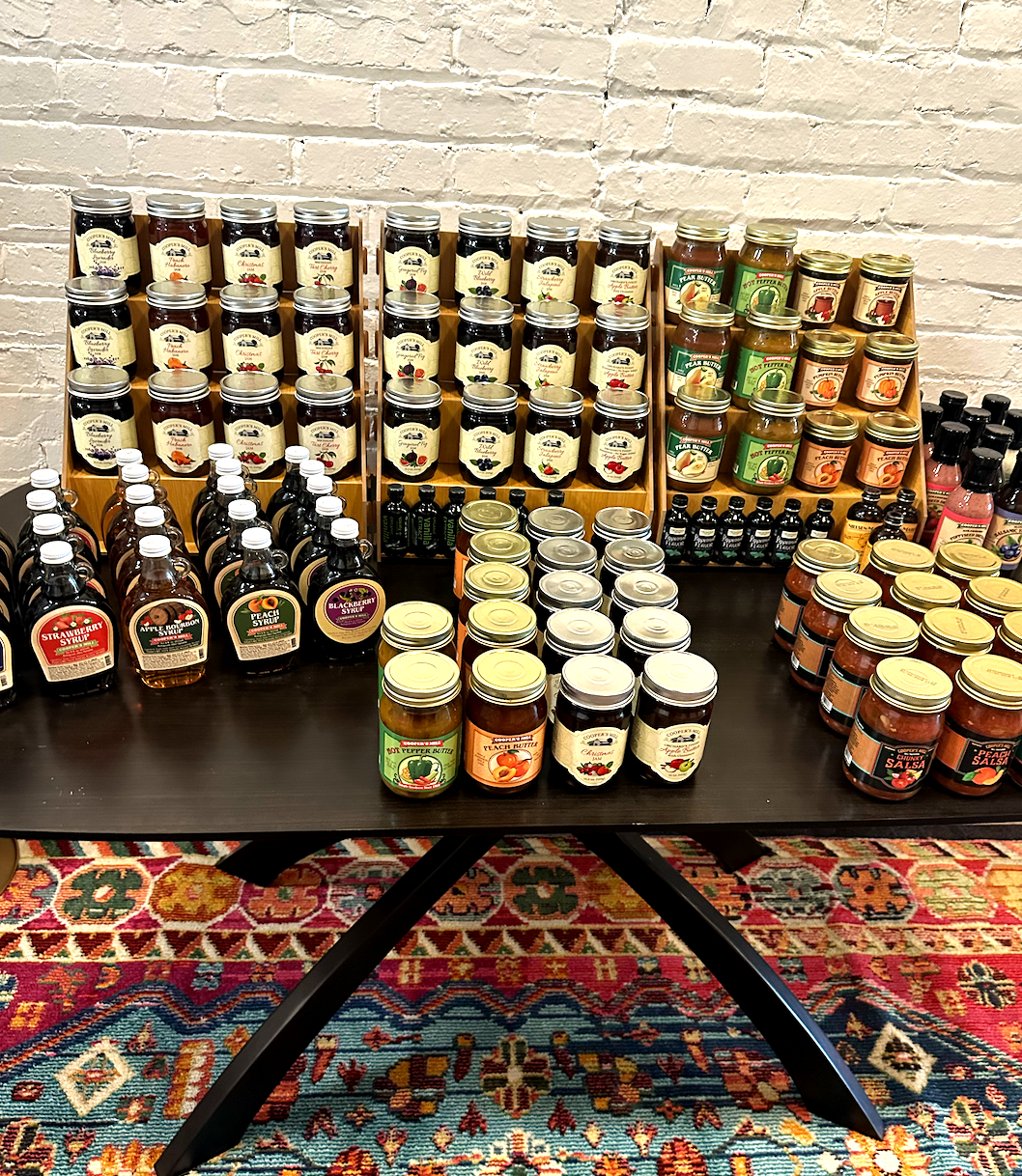A table filled with jars and bottles of food.