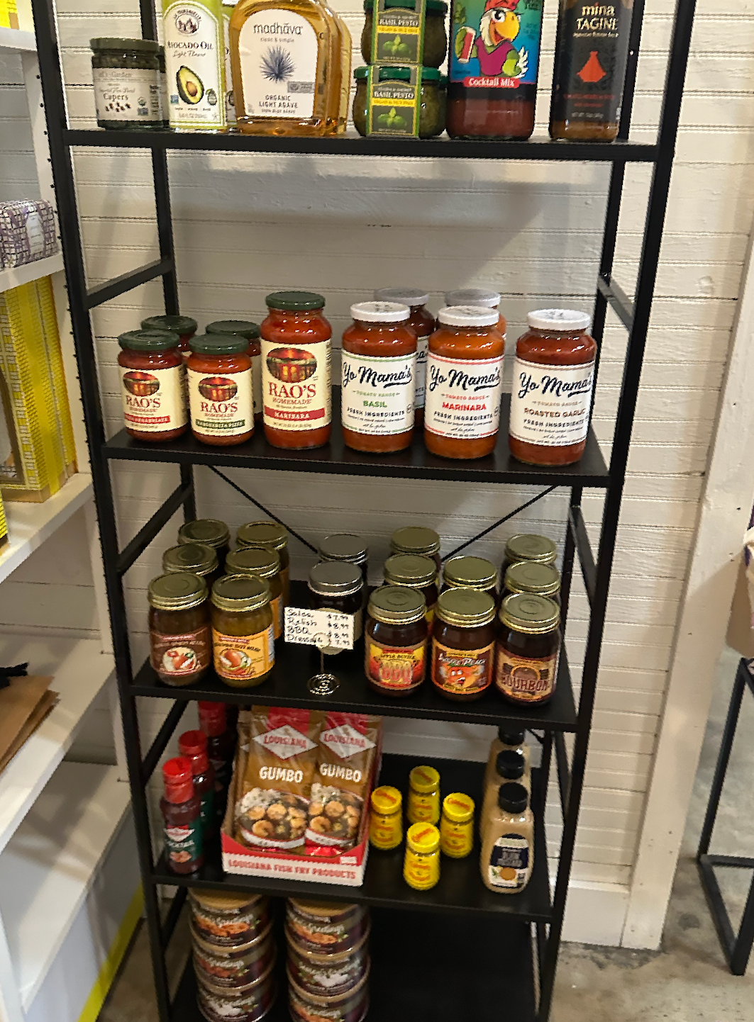 A shelf filled with jars of food in a store.